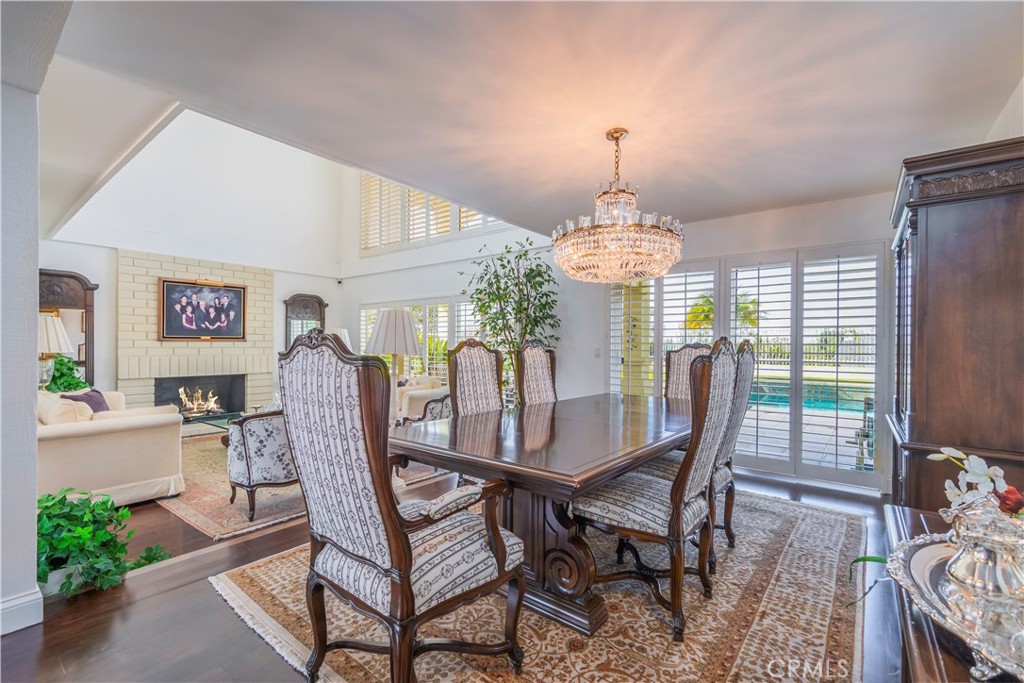 8213 Seranata Drive Whittier, CA 90603 - Photo 10 of 64 a dining room with furniture a chandelier and wooden floor