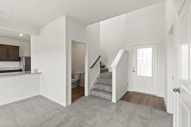 an empty room with a ceiling fan and a window