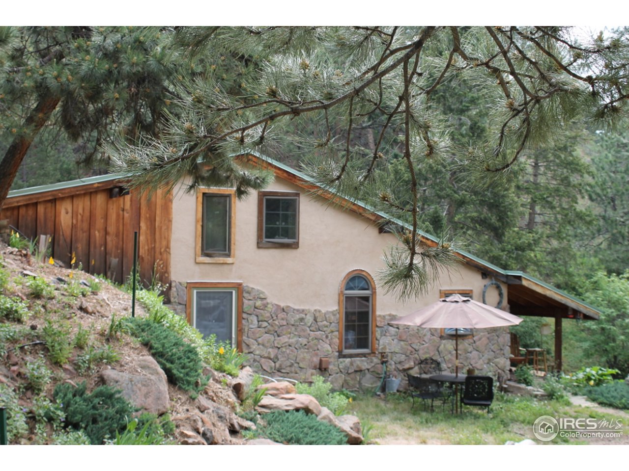 11220 Rist Canyon Road Bellvue, CO 80512 - Photo 4 of 25 a front view of house with yard and trees in the background