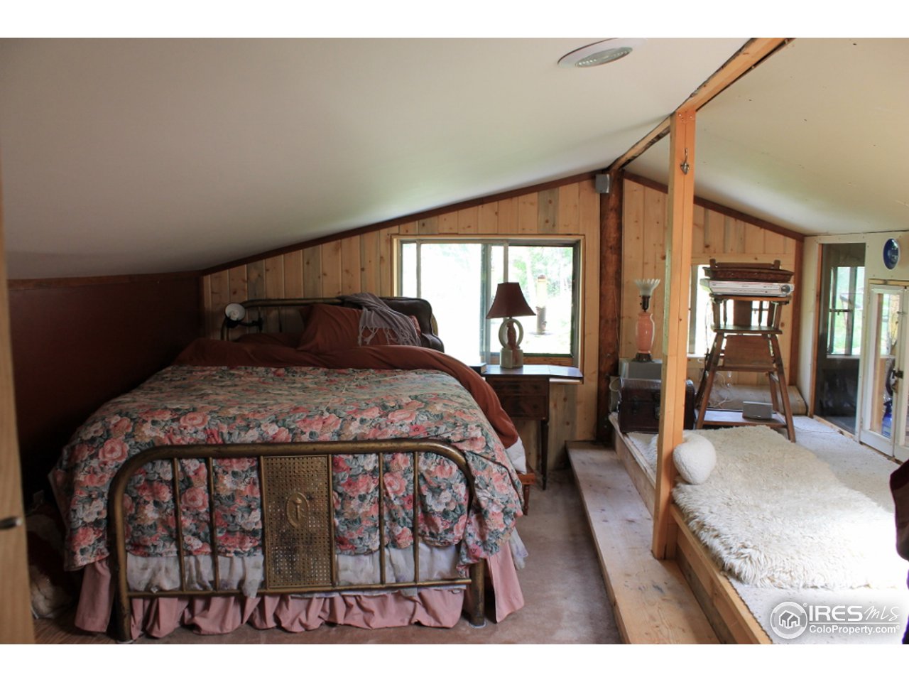 11220 Rist Canyon Road Bellvue, CO 80512 - Photo 8 of 25 a bedroom with a bed a table and chair
