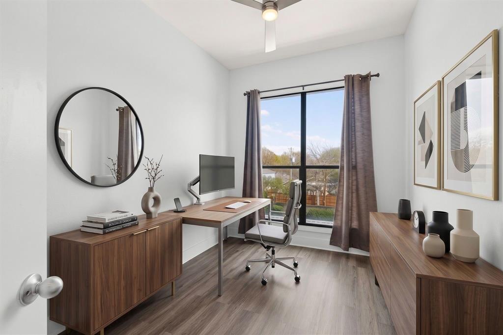 4414 Cedar Springs Road, Unit 318 Dallas, TX 75219 - Photo 28 of 40 Bright room with wood-finish flooring, a contemporary ceiling fan, and a large window featuring black trim