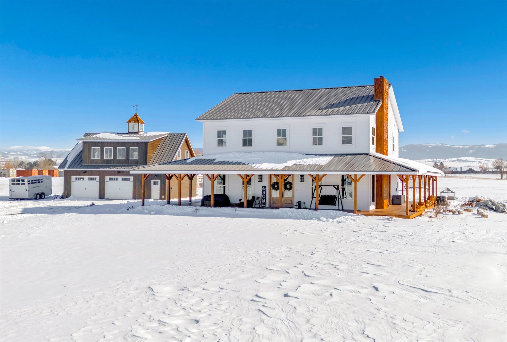 4512 Illinois Bench Road Stevensville, MT 59870 - Photo 1 of 1 Snow covered back of property featuring a porch and a mountain view