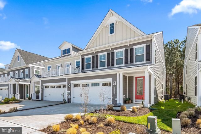 a front view of a house with swimming pool and glass windows