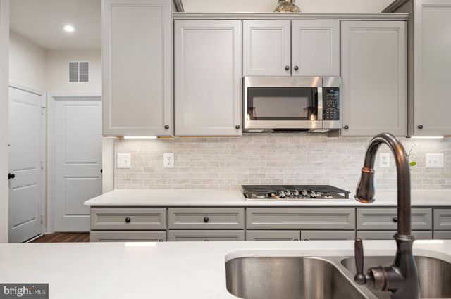 a kitchen with a stove and a microwave