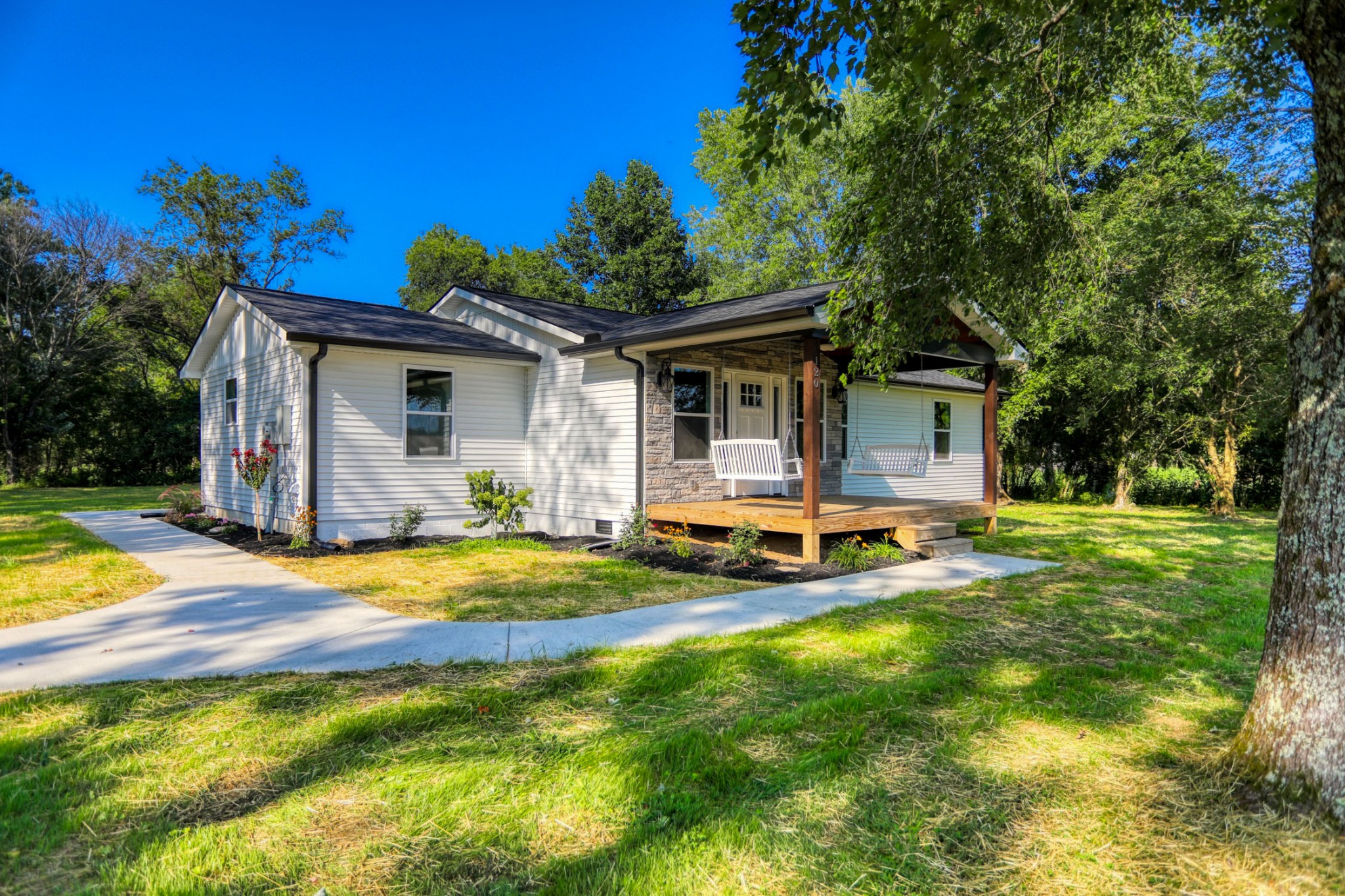 a view of a house with swimming pool and sitting area
