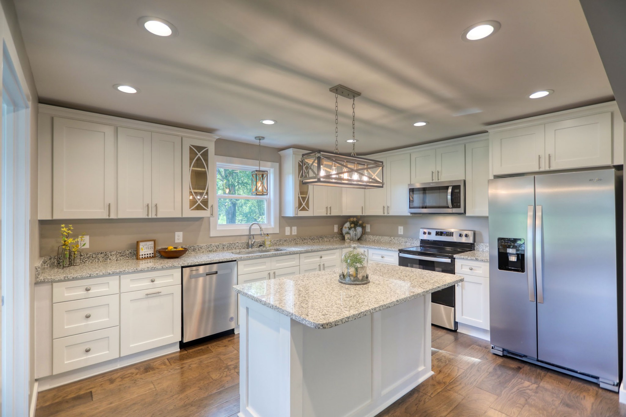 120 Vantrease Road Cottontown, TN 37048 - Photo 11 of 31 a kitchen with a sink a stove a refrigerator and white cabinets with wooden floor