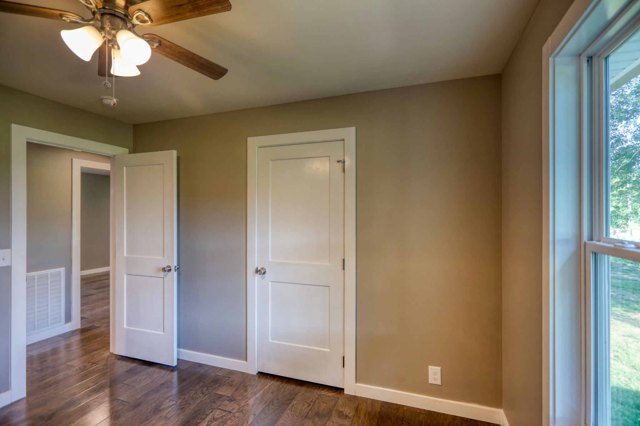 120 Vantrease Road Cottontown, TN 37048 - Photo 21 of 31 an empty room with wooden floor fan and windows