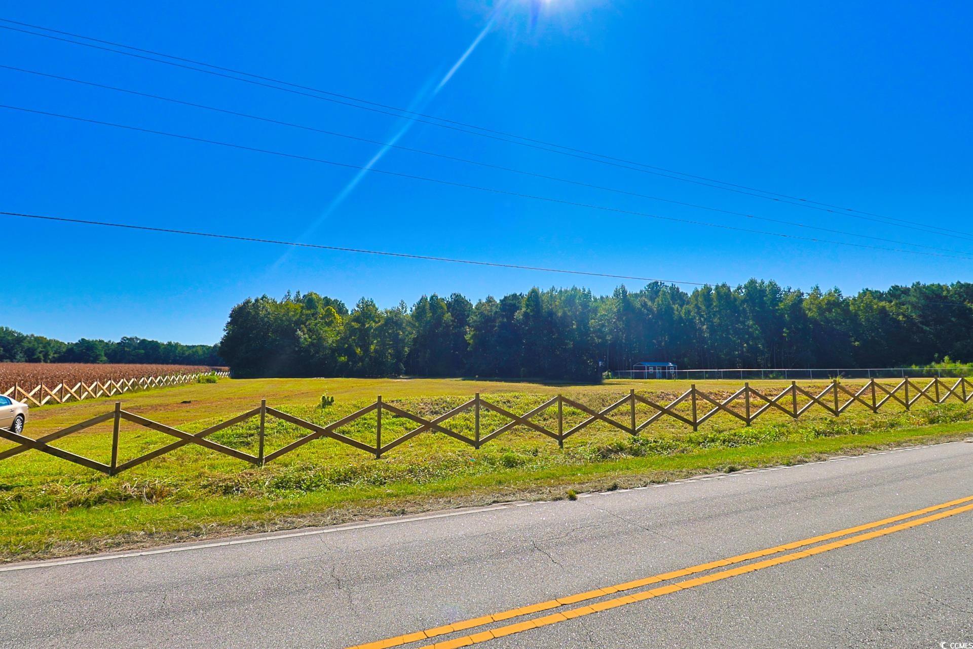 View of asphalt street with a rural view