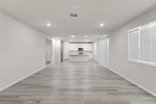 a view of kitchen with refrigerator and window