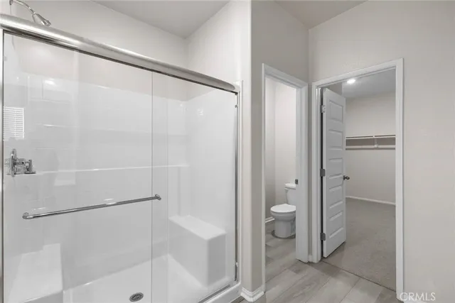 a bathroom with a shower and a glass door