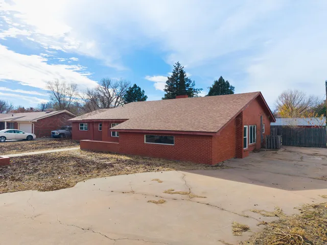 a view of a house with a yard covered in snow