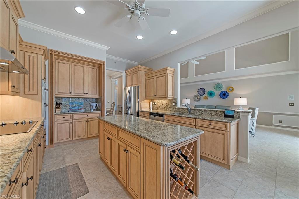 2004 Timarron Way Naples, FL 34109 - Photo 16 of 30 a kitchen with stainless steel appliances granite countertop a stove a sink and a refrigerator