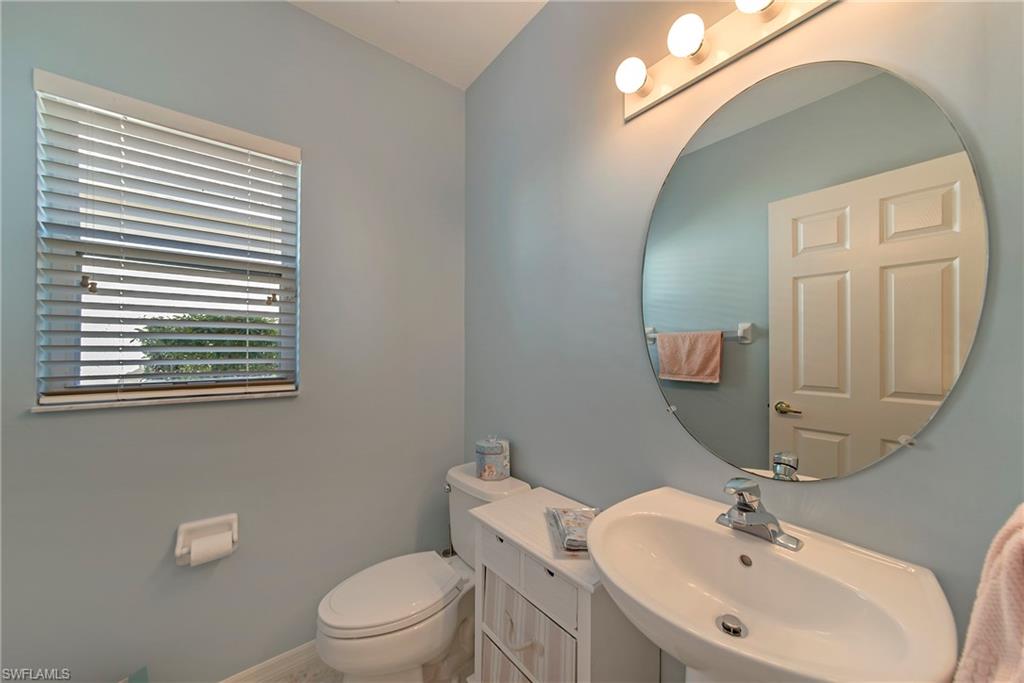 2004 Timarron Way Naples, FL 34109 - Photo 18 of 30 a bathroom with a toilet a sink and mirror