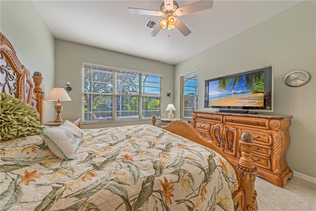 2004 Timarron Way Naples, FL 34109 - Photo 19 of 30 a bedroom with a bed and wooden floor
