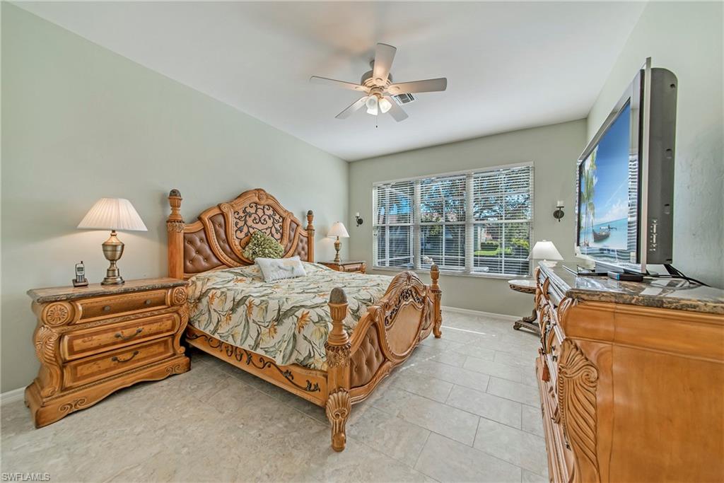 2004 Timarron Way Naples, FL 34109 - Photo 21 of 30 a bed room with a bed and a chandelier