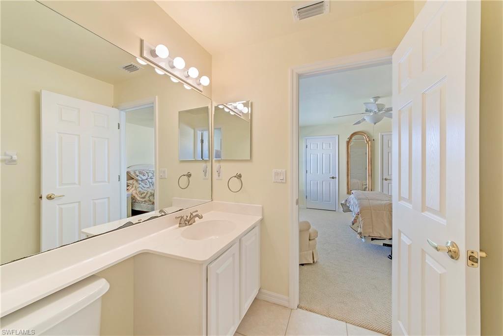 2004 Timarron Way Naples, FL 34109 - Photo 27 of 30 a spacious bathroom with a sink a mirror and a shower