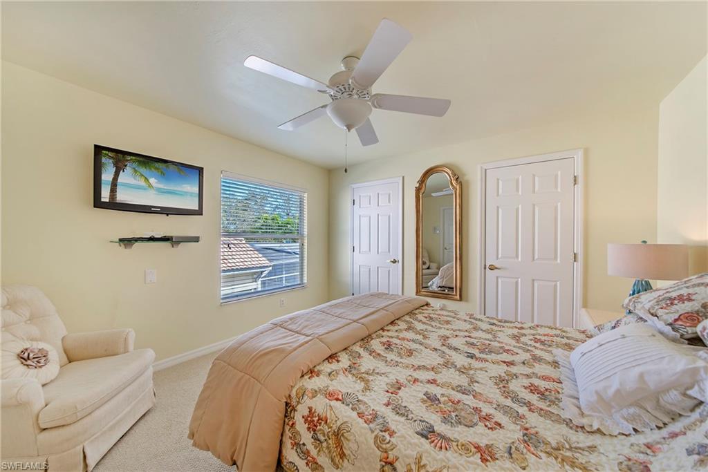 2004 Timarron Way Naples, FL 34109 - Photo 28 of 30 a bedroom with a bed and a painting on the wall