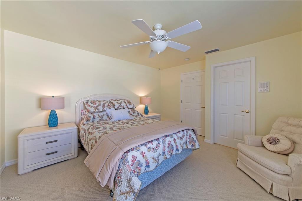 2004 Timarron Way Naples, FL 34109 - Photo 29 of 30 a bedroom with a bed and a ceiling fan