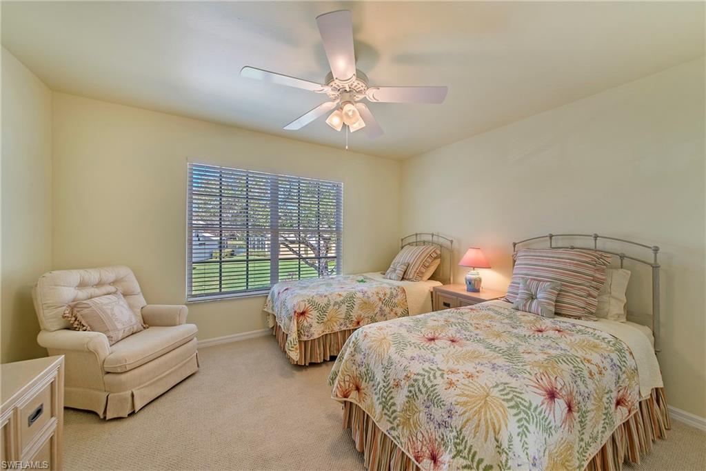 2004 Timarron Way Naples, FL 34109 - Photo 30 of 30 a spacious bedroom with two bed and a large window