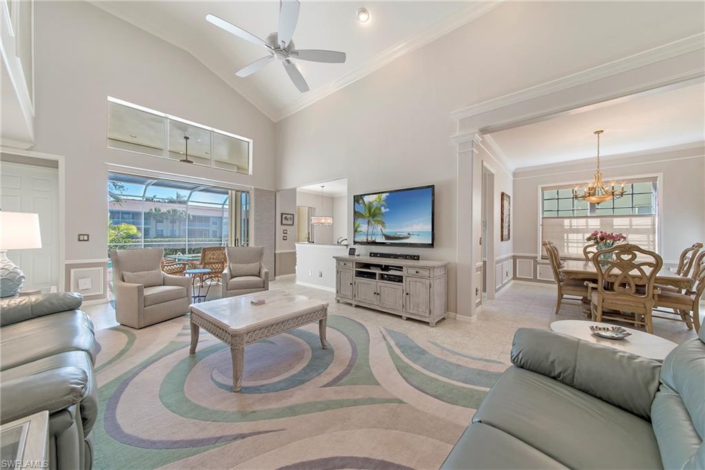 2004 Timarron Way Naples, FL 34109 - Photo 4 of 30 a living room with furniture and a flat screen tv