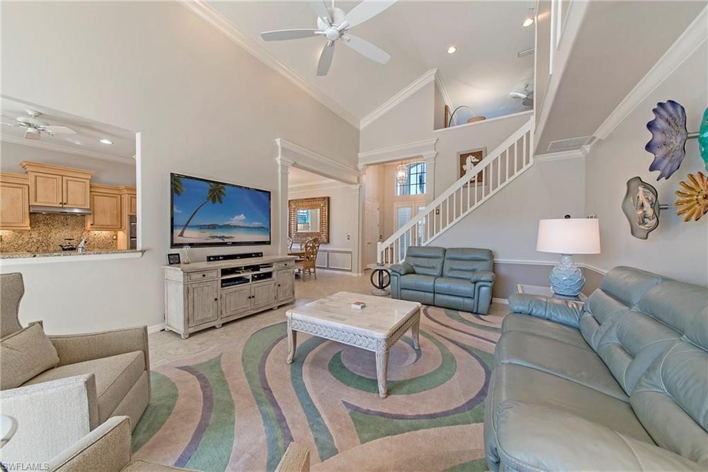 2004 Timarron Way Naples, FL 34109 - Photo 6 of 30 a living room with furniture and a flat screen tv