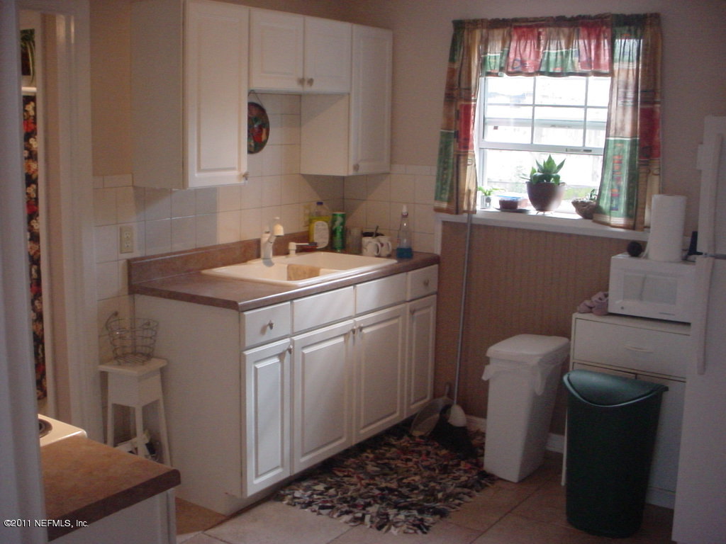 10454 Stone Road Jacksonville, FL 32246 - Photo 7 of 14 a room with a sink cabinets and a window