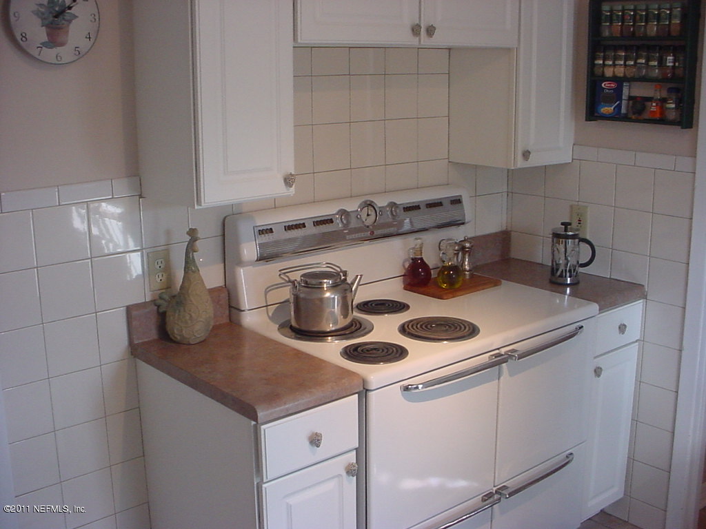 10454 Stone Road Jacksonville, FL 32246 - Photo 9 of 14 a kitchen with a sink a stove and cabinets