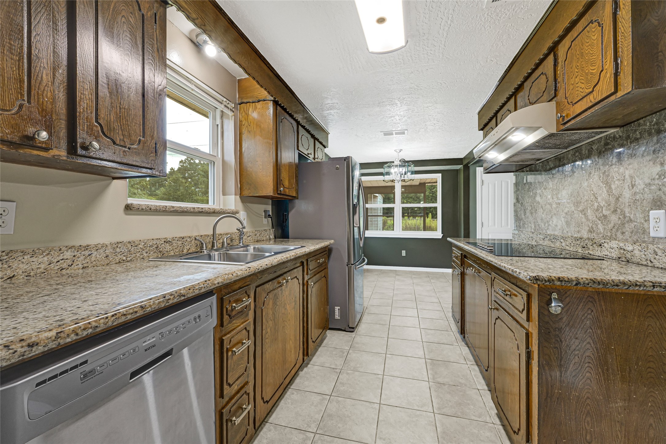 20135 Timber Line Lane New Caney, TX 77357 - Photo 14 of 30 a kitchen with stainless steel appliances granite countertop a sink stove and cabinets