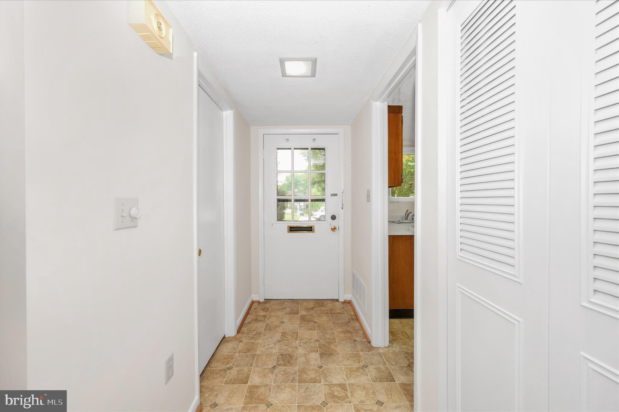 3261 South Leisure World Boulevard, Unit 108F Silver Spring, MD 20906 - Photo 3 of 81 Foyer with closet and half bath/laundry