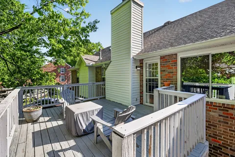 a view of balcony with wooden floor and outdoor seating