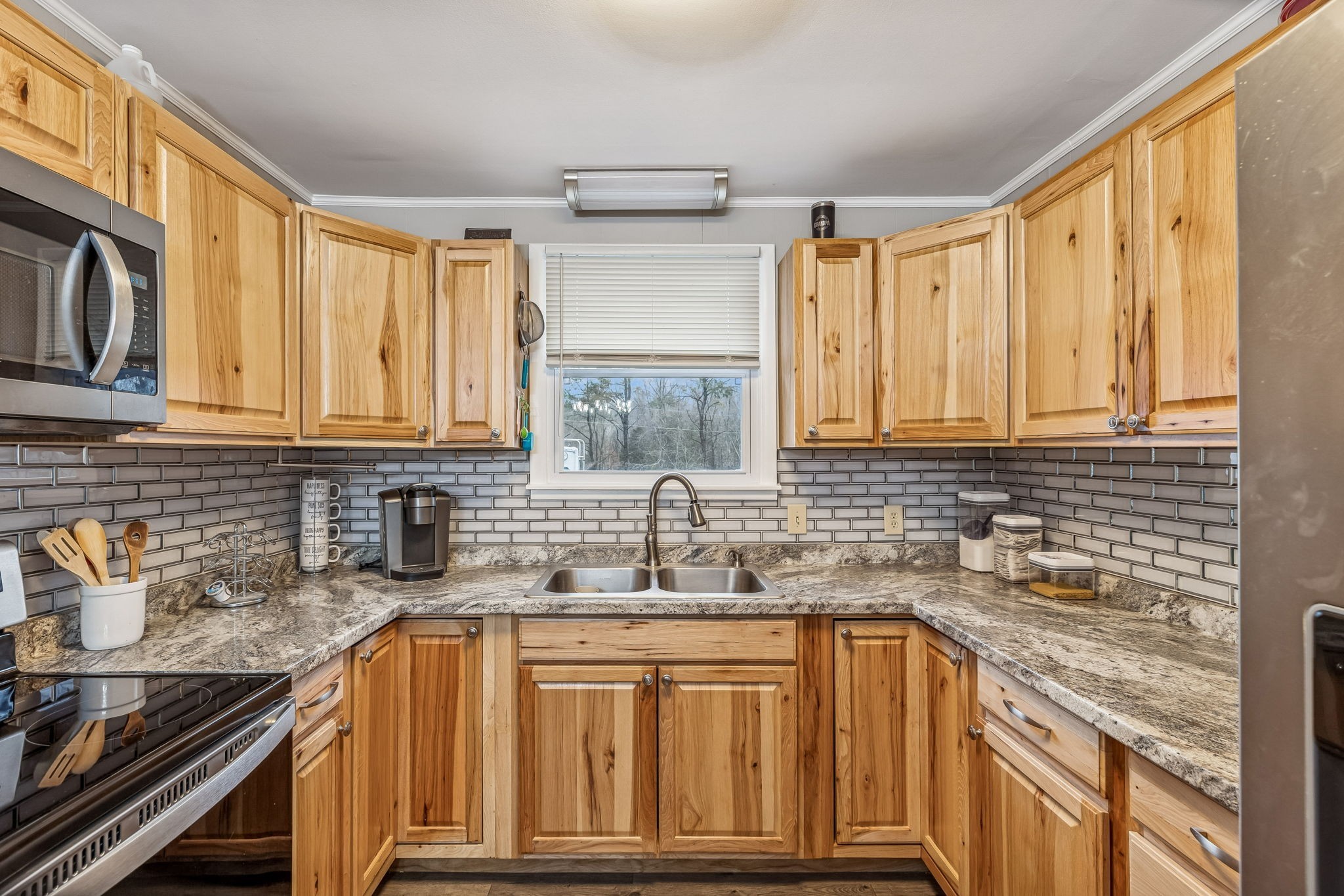 8871 Pinewood Road Lyles, TN 37098 - Photo 12 of 35 a kitchen with stainless steel appliances granite countertop a sink stove and cabinets