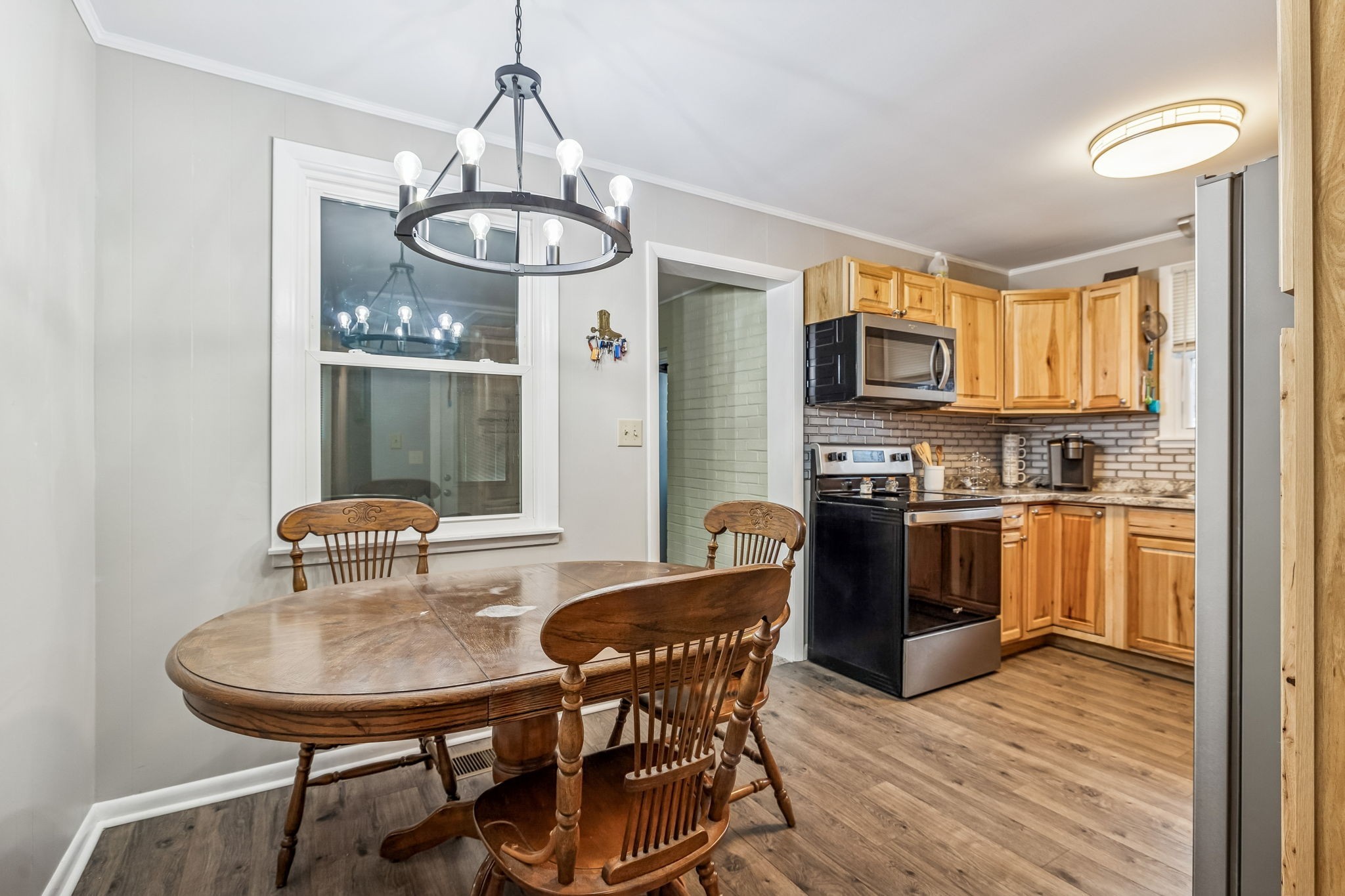 8871 Pinewood Road Lyles, TN 37098 - Photo 13 of 35 a view of a dining room with furniture window and wooden floor