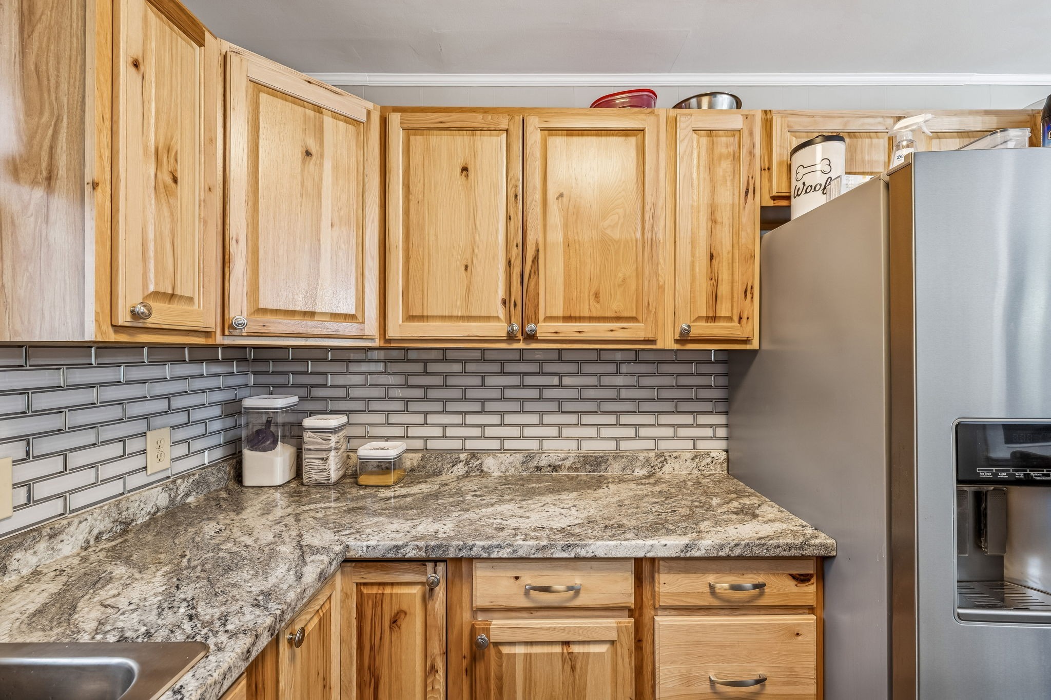 8871 Pinewood Road Lyles, TN 37098 - Photo 9 of 35 a kitchen with granite countertop a sink and a refrigerator