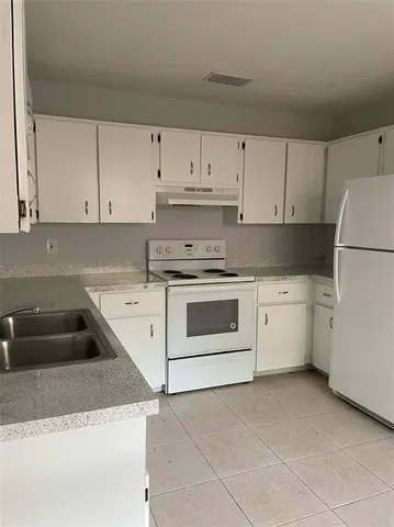 a kitchen with cabinets appliances and a sink