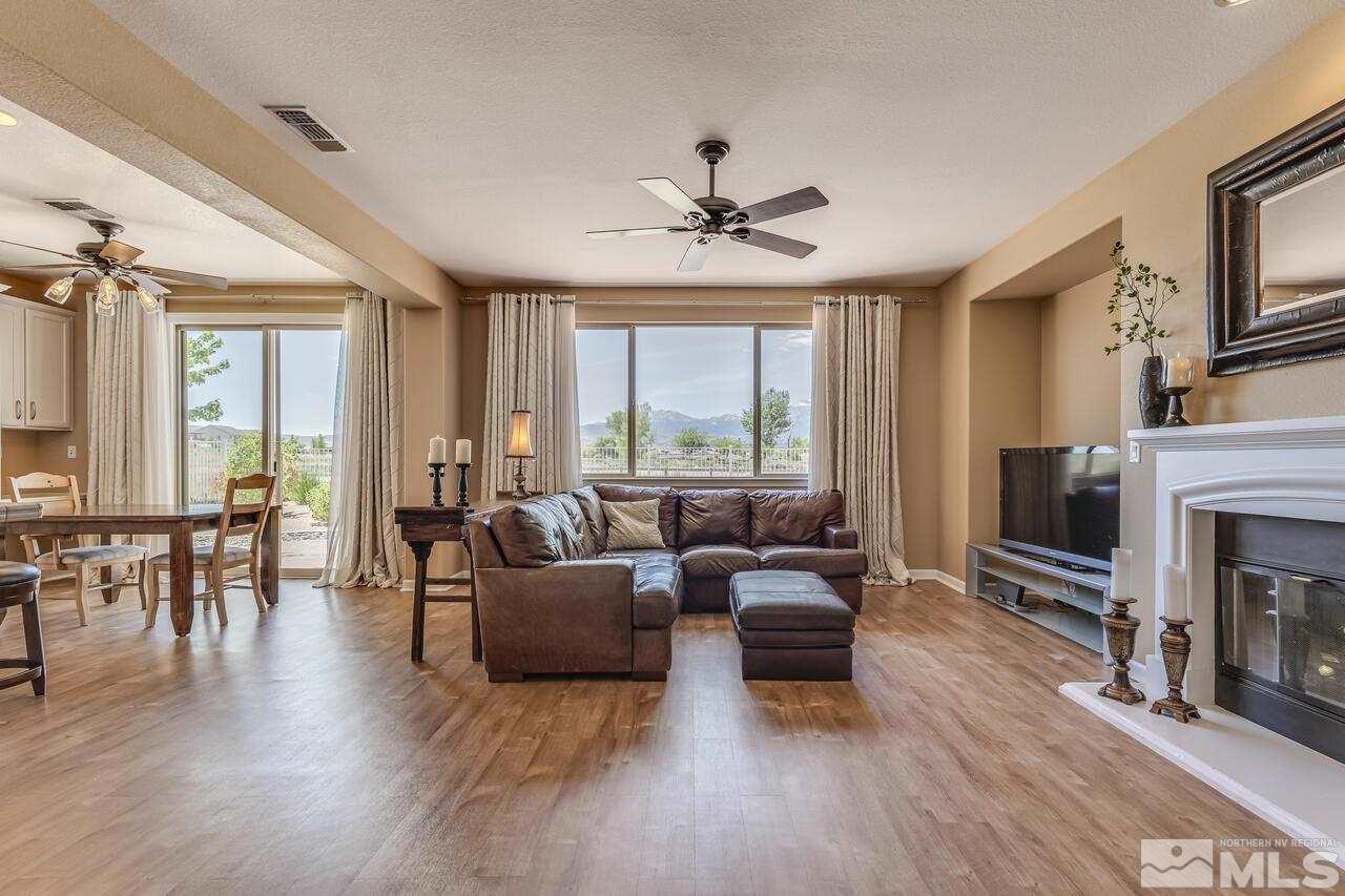 10669 Fire Poppy Circle Reno, NV 89521 - Photo 6 of 24 a living room with furniture large window and fireplace
