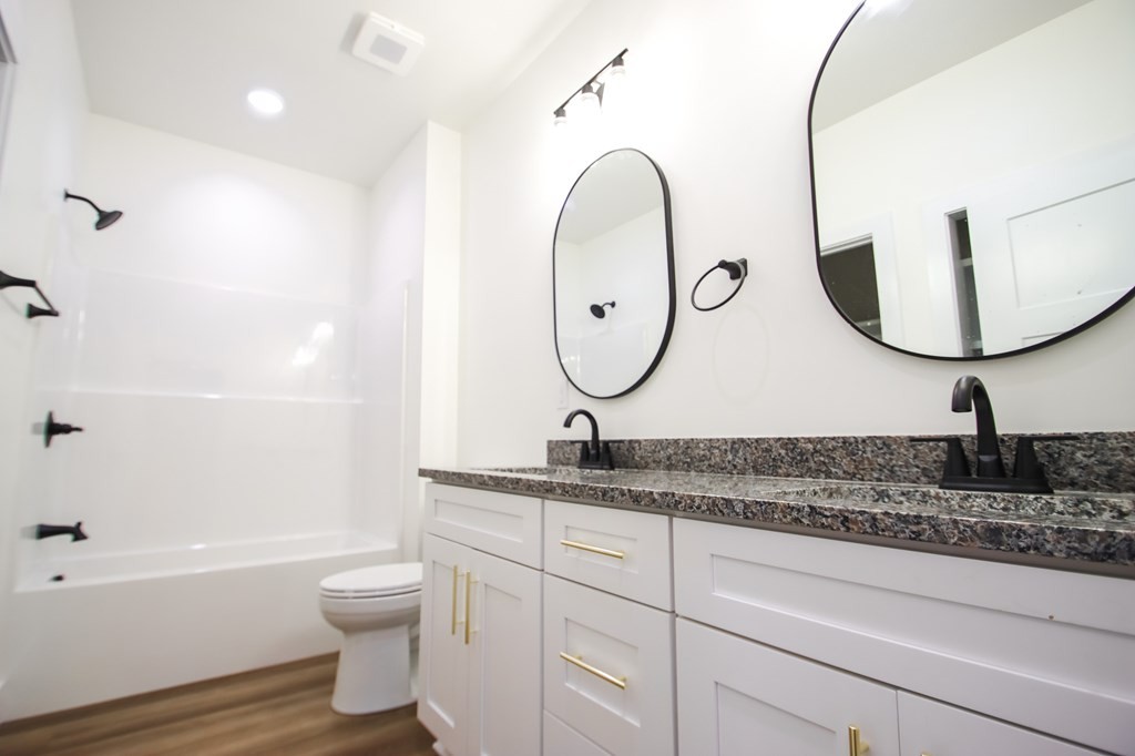 329 Webb Drive Sparta, TN 38583 - Photo 10 of 17 a bathroom with a toilet a sink and a mirror