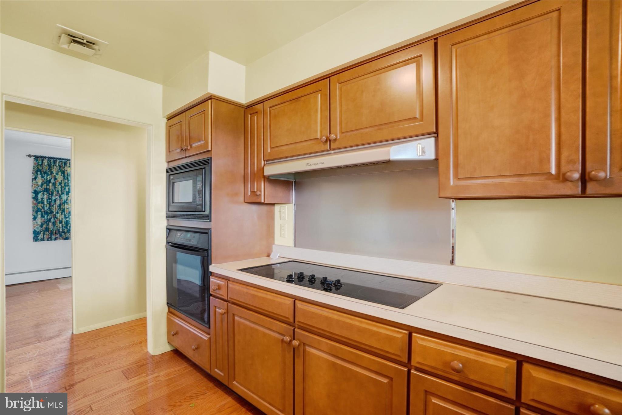 47 Rocks Road Fawn Grove, PA 17321 - Photo 12 of 29 a kitchen with stainless steel appliances granite countertop a sink cabinets and a wooden floor