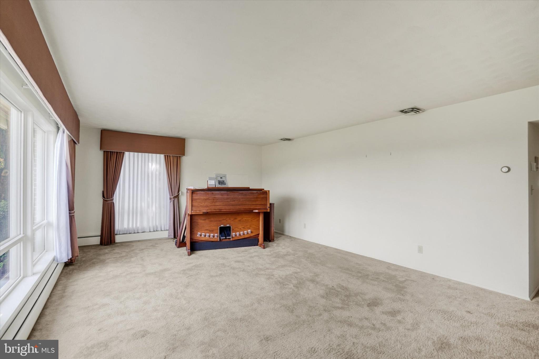 47 Rocks Road Fawn Grove, PA 17321 - Photo 6 of 29 an empty room with a fireplace and window