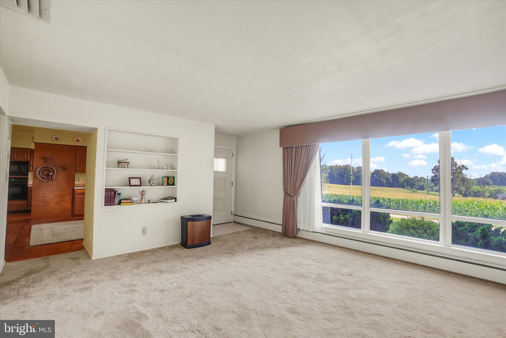 47 Rocks Road Fawn Grove, PA 17321 - Photo 7 of 29 an empty room with furniture and a large window