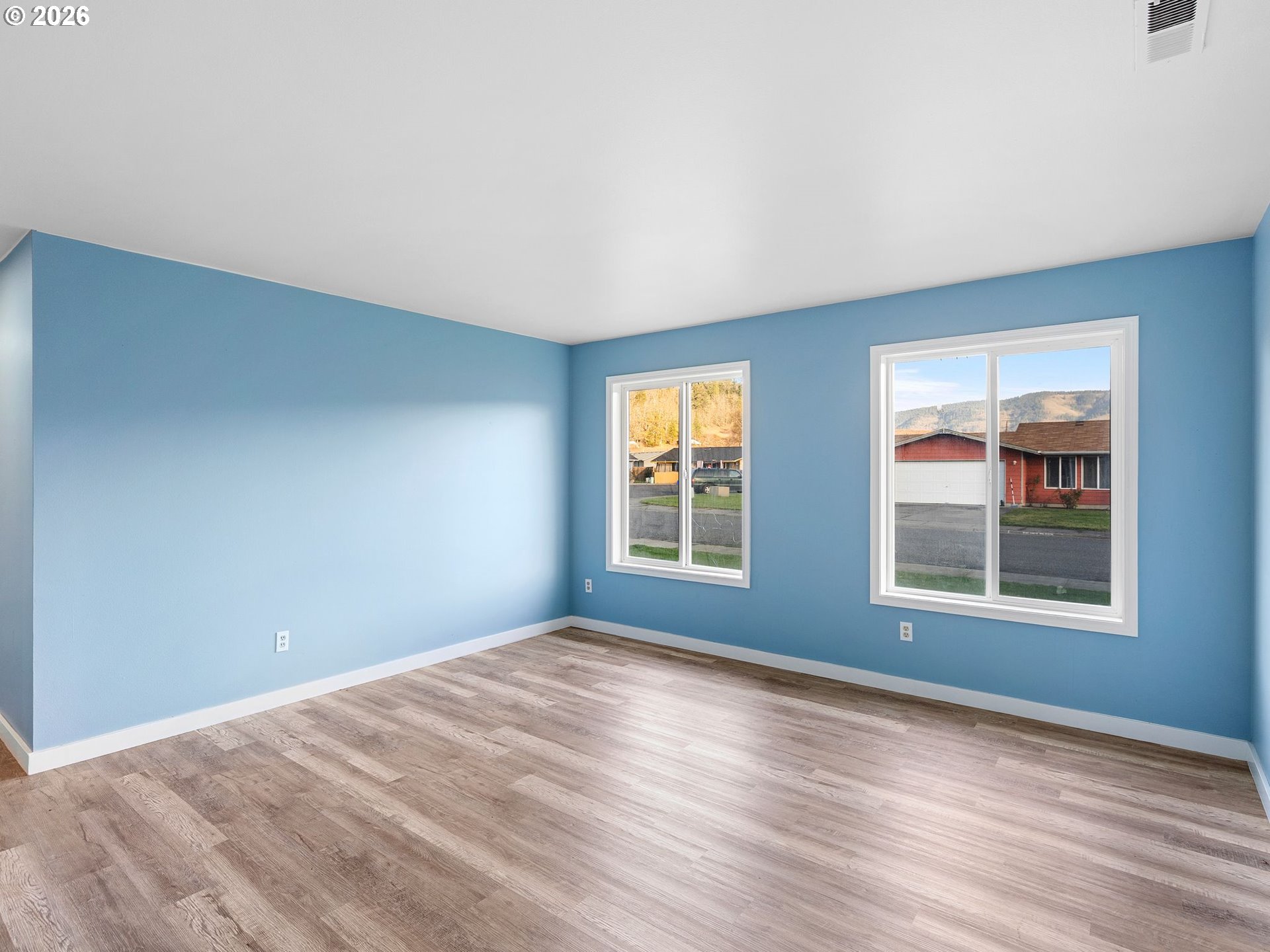 3220 Midway Road Hood River, OR 97031 - Photo 11 of 39 a view of an empty room with wooden floor and a window