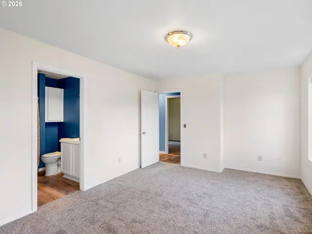 a view of a room with wooden floor and bathroom