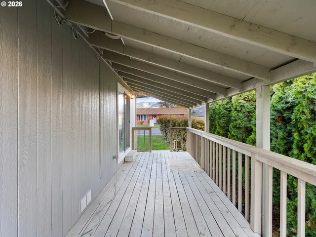 a view of a balcony with wooden floor