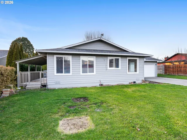 a front view of a house with a garden
