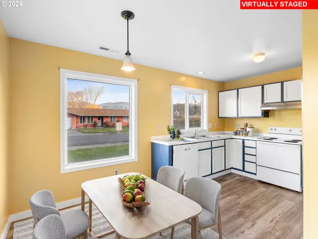 a kitchen that has a counter space and a chair in it