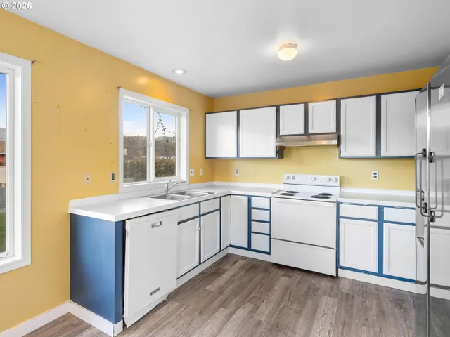 a kitchen with a sink stove and cabinets