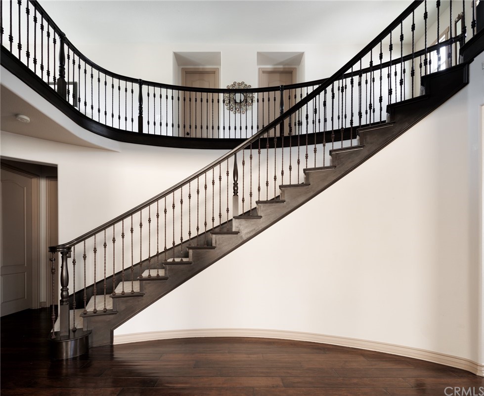 8 Kane Lane Ladera Ranch, CA 92694 - Photo 14 of 29 a view of staircase with wooden floor and white walls
