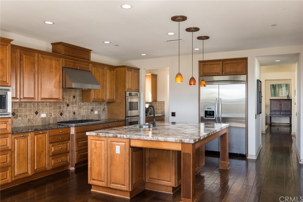8 Kane Lane Ladera Ranch, CA 92694 - Photo 10 of 29 a kitchen with stainless steel appliances granite countertop a sink a stove and a refrigerator