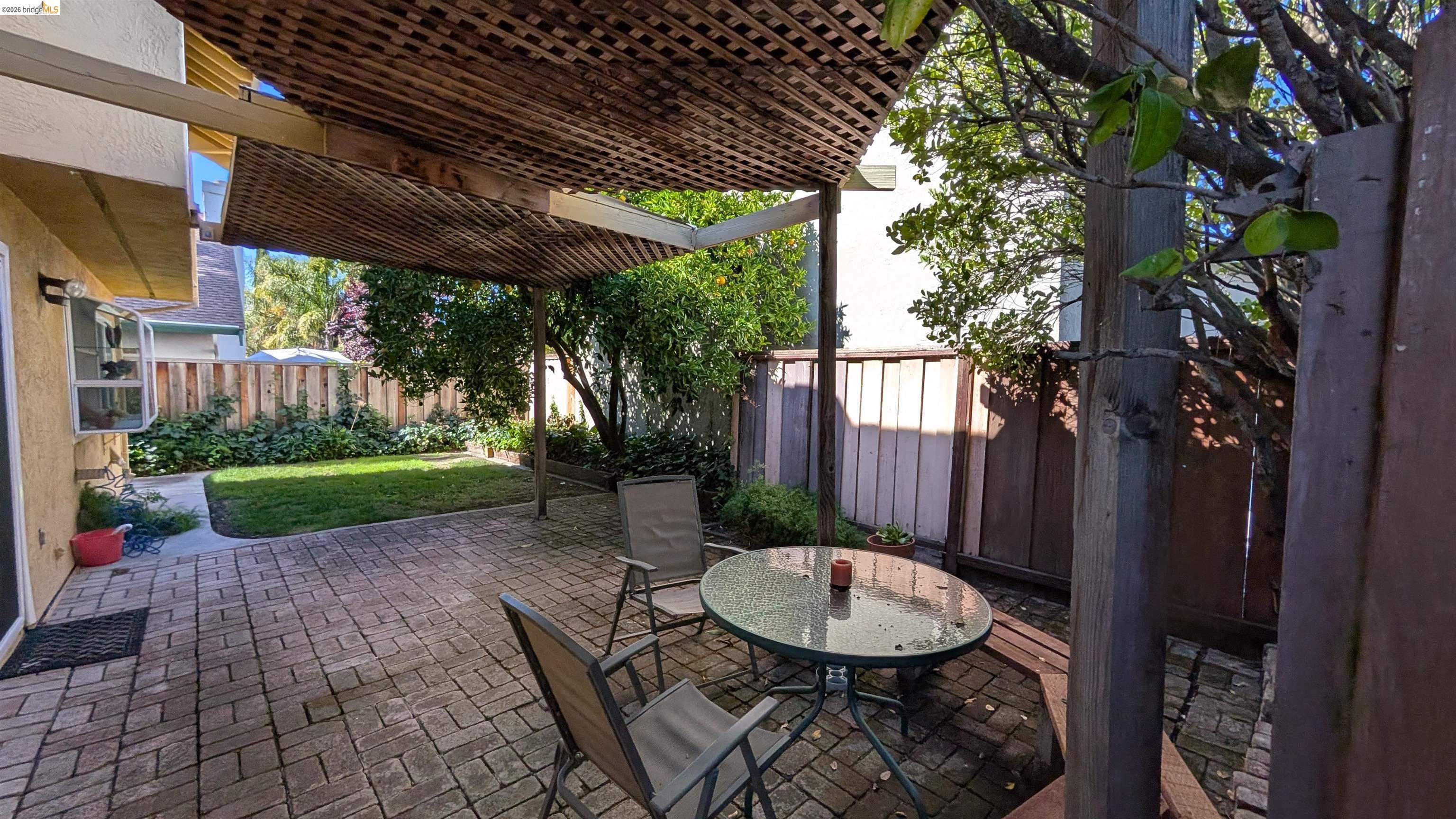 10013 Foxboro Circle San Ramon, CA 94583 - Photo 31 of 39 a view of a backyard with table and chairs potted plants and floor to ceiling window