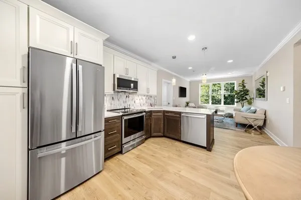 a kitchen with a refrigerator sink and stainless steel appliances