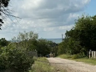 a view of a field with trees in the background